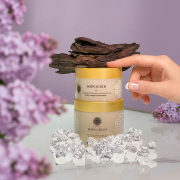 Assemble K - Play .Try .Glow Tiela Body Scrub and Body Cream jars with citrus-floral-woody scent, featuring natural ingredients for soft, hydrated skin.