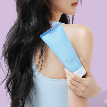 Assemble K - Play .Try .Glow NOT4U Clear Acfit Body Pack Scrub 220g, a light blue tube dispensing white scrub onto a hand.
