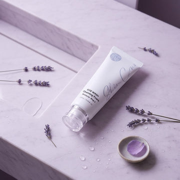 Assemble K - Play .Try .Glow white cleansing foam tube with clear cap on marble countertop.