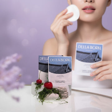 Assemble K - Play .Try .Glow Della Born Cherry Bubble Cleansing Pad packaging with cherry and moss accents.