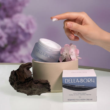 Assemble K - Play .Try .Glow Della Born Marine Collagen Cream jar and box with pink flowers and driftwood.