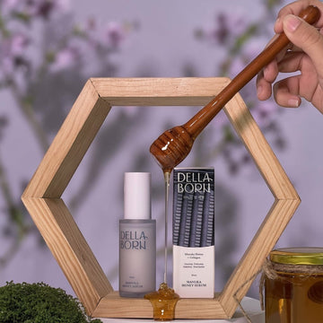 Assemble K - Play .Try .Glow: Della Born Manuka Honey Serum 30ml bottle and box with honey dripping from a wooden dipper.