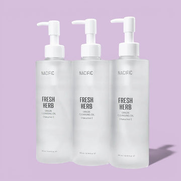 Assemble K - Play .Try .Glow holds NACIFIC Fresh Herb Origin Cleansing Oil with Bakuchiol, a clear oil in a frosted bottle with a pump dispenser.