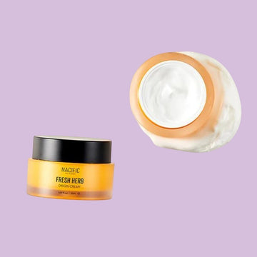Assemble K - Play .Try .Glow NACIFIC Fresh Herb Origin Cream in a yellow jar with a white cream texture, 50ml.