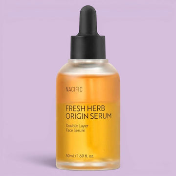 Assemble K - Play .Try .Glow Nacific Fresh Herb Origin Serum, a double-layer face serum in a clear bottle with a black dropper, featuring a golden liquid and citrus accents.