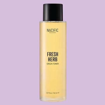 Assemble K - Play .Try .Glow NACIFIC Fresh Herb Origin Toner, a golden-hued liquid in a clear bottle with a black cap, designed to soothe and nourish skin.