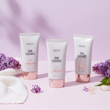 Assemble K - Play .Try .Glow NACIFIC Sun Essence SPF 50+ PA++++, lightweight hydrating sunscreen in a white tube with a rose gold cap.