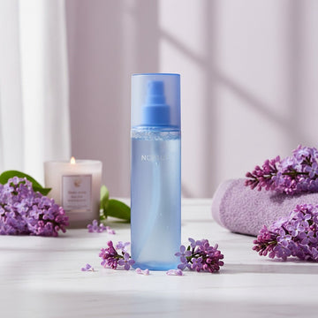 Assemble K - Play .Try .Glow NOT4U Clear Body Mist 200ml, a translucent blue spray bottle with a blue cap and pump.