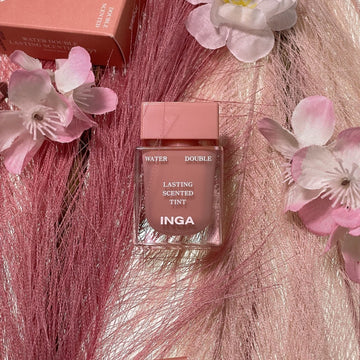 Assemble K - Play .Try .Glow Inga Water Double Lasting Scented Tint in Nudey Rosy, a sheer rosy-pink lip tint with a glossy finish, shown with its packaging.