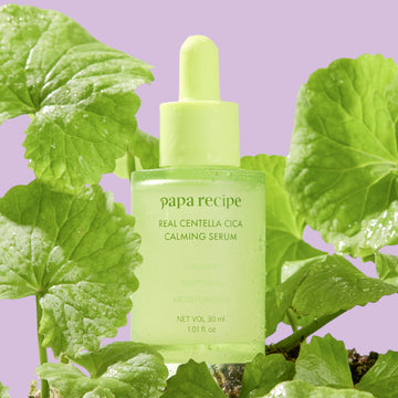 Assemble K - Play .Try .Glow: Papa Recipe Real Centella Cica Calming Serum in a green glass bottle with a dropper, featuring calming, soothing, and moisturizing properties.