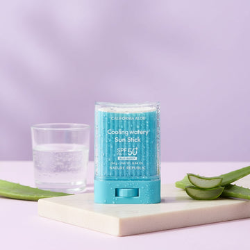 Assemble K - Play .Try .Glow NATURE REPUBLIC California Aloe cooling sun stick with SPF50+ on a marble surface.