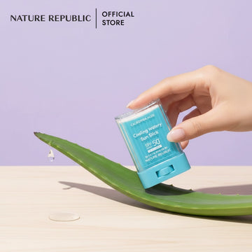 Assemble K - Play .Try .Glow NATURE REPUBLIC California Aloe cooling sun stick held over a fresh aloe vera leaf