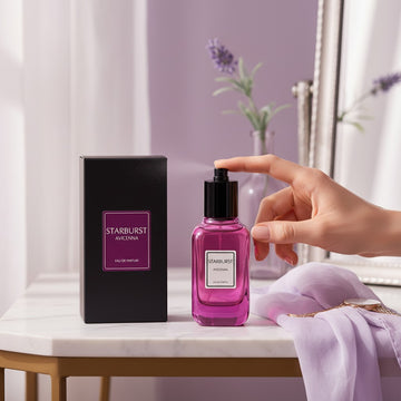 Assemble K - Play .Try .Glow Avicenna Starburst perfume bottle being sprayed on a marble table with its black box.