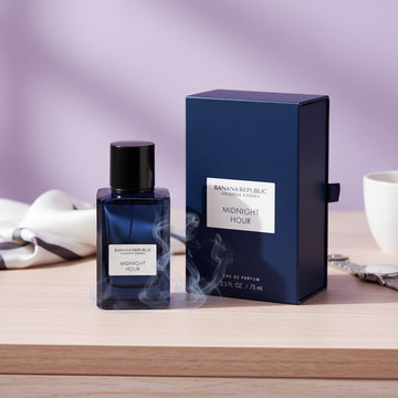 Assemble K - Play .Try .Glow Banana Republic Midnight Hour unisex perfume bottle and dark blue box on a wooden table.