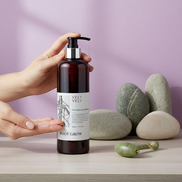 Assemble K - Play .Try .Glow hair loss control shampoo in a brown pump bottle held by hands against a purple background