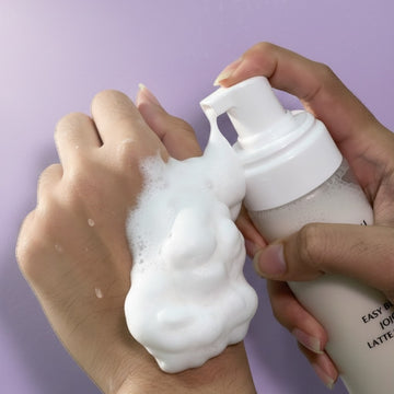 Assemble K - Play .Try .Glow Easy Bubble Jojoba Latte Cleanser foaming onto a hand.