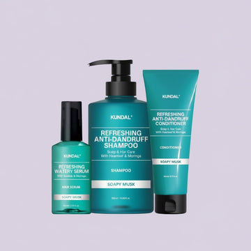 Assemble K - Play .Try .Glow Kundal Refreshing Anti-Dandruff Shampoo, Conditioner, and Hair Serum set in teal bottles with Soapy Musk scent.