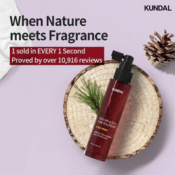 Assemble K - Play .Try .Glow Kundal Head SPA & Scalp Care+ Scalp Spray 100ml, a dark red bottle with a black spray nozzle, on a wood slice with pine needles.