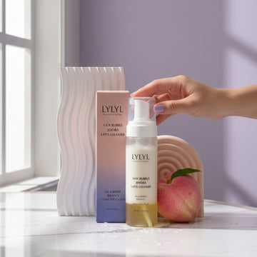 Assemble K - Play .Try .Glow LYLYL Easy Bubble Jojoba Latte Cleanser with peach accent. Oil & foam formula.