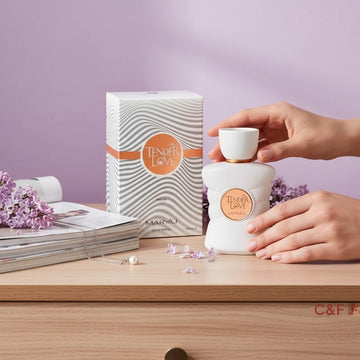 Assemble K - Play .Try .Glow Maryaj Tender Love perfume bottle and box on a wooden table with lilac flowers