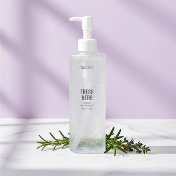 Assemble K - Play .Try .Glow NACIFIC Fresh Herb Origin Cleansing Oil in a clear pump bottle with fresh rosemary sprigs