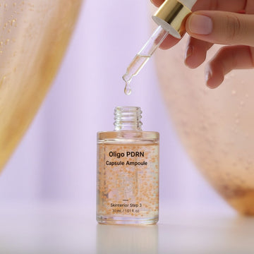 Assemble K - Play .Try .Glow Skinterior Step 3 Oligo PDRN Capsule Ampoule with small orange beads suspended in clear serum.