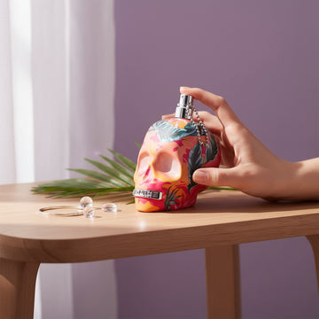 Assemble K - Play .Try .Glow Police To Be Exotic Jungle perfume bottle with tropical floral print on a wooden table
