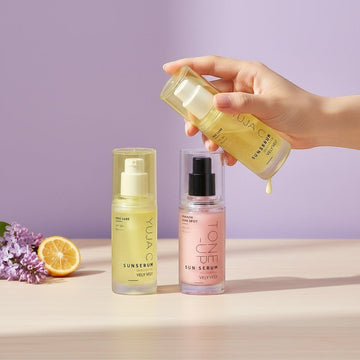 Assemble K - Play .Try .Glow brightening and tone-up sunserum bottles with yellow and pink formulas on a table.