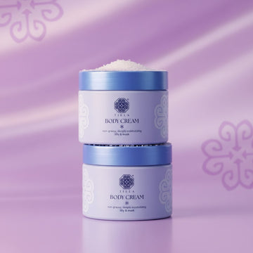 Assemble K - Play .Try .Glow Tiela Perfume Therapy Body Cream Pure 200g in light blue packaging with floral design, featuring coconut floral woody scent.