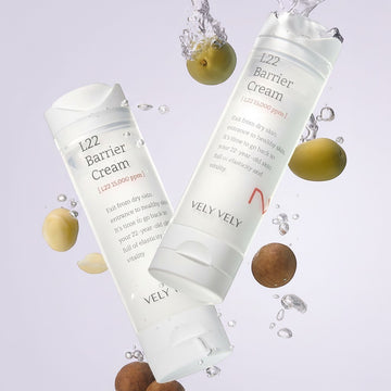 Assemble K - Play .Try .Glow VELY VELY L22 Barrier Cream 50ml, a white tube with L22 Barrier Cream text, surrounded by water splashes and nuts.