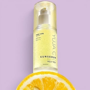 Assemble K - Play .Try .Glow Vely Vely Yuja C Sunserum with SPF 50+ for pore care and brightening on a purple background