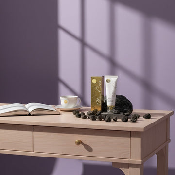 Assemble K - Play .Try .Glow Step 1 Returning Sleeping Pack tube and box with gold accents, surrounded by dark stones.