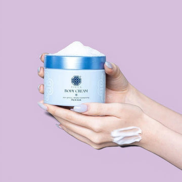 Assemble K - Play .Try .Glow Tiela Body Cream in a light purple jar with a blue lid, featuring a floral design and text indicating a coconut floral woody scent.