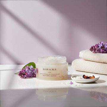 Assemble K - Play .Try .Glow Body Scrub in plum & white cedarwood scent. Gentle exfoliating and moisturizing sugar scrub in a clear jar with a dark red lid.