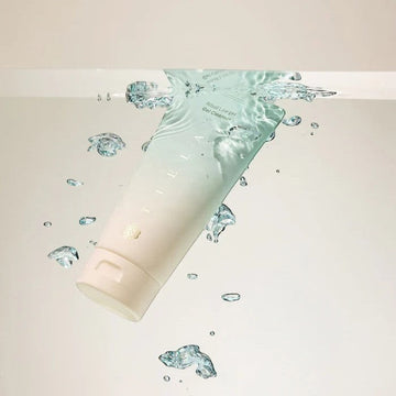 Assemble K - Play .Try .Glow Tiela Ritual Low pH Gel Cleanser tube and box with a drop of cleanser falling from a finger.