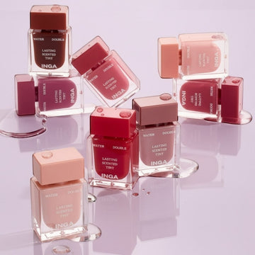 Assemble K - Play .Try .Glow Inga Water Double Lasting Scented Tint in various shades of pink, red, and brown. Clear bottles with colored caps.