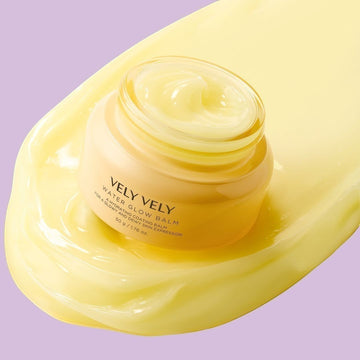 Assemble K - Play .Try .Glow VELY VELY Water Glow Balm 50g jar and box with a yellow flower on a pink arch.