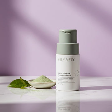 Assemble K - Play .Try .Glow VELY VELY Enzyme Greentea Powder Cleanser in a white bottle with a grey cap. 60g.