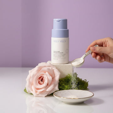 Assemble K - Play .Try .Glow VELY VELY Enzyme Milk Powder Cleanser in a white bottle with a lavender cap, featuring a pink rose and green moss.