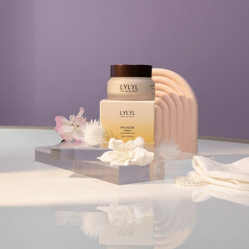 LYLYL Vita ABCDE Cream jar and box with Glutathione & HPR, featuring delicate pink and white flowers on acrylic stands.