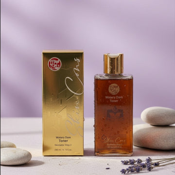 Assemble K - Play .Try .Glow Skinterior Step 2 Watery Dam Toner in amber glass bottle with gold cap. Includes box.