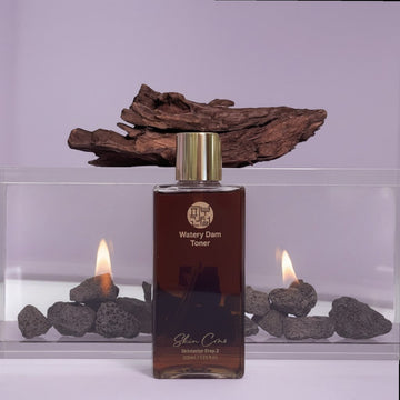 Assemble K - Play .Try .Glow Skinterior Step 2 Watery Dam Toner, a clear hydrating toner in a brown bottle with a gold cap.