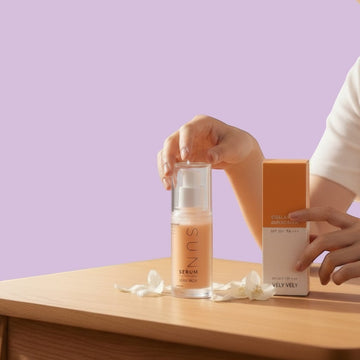 Assemble K - Play .Try .Glow presents VELYVELY Collagen Sun Serum 30ml SPF 50+ PA++++ in a clear pump bottle with orange accents.